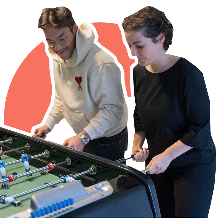 Two ZBO Media employees playing table football